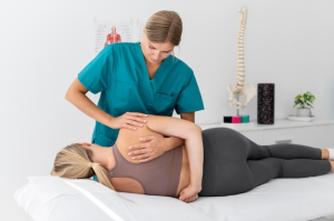 a chiropractor with her hands on a woman’s back